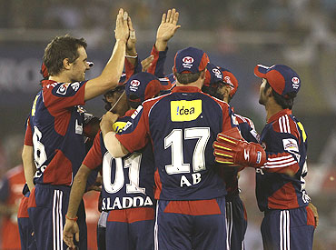 The Delhi Daredevils players celebrate after picking the wicket of Swapnil Asnodkar