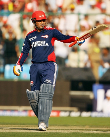 Virender Sehwag acknowledges the applause after scoring 50
