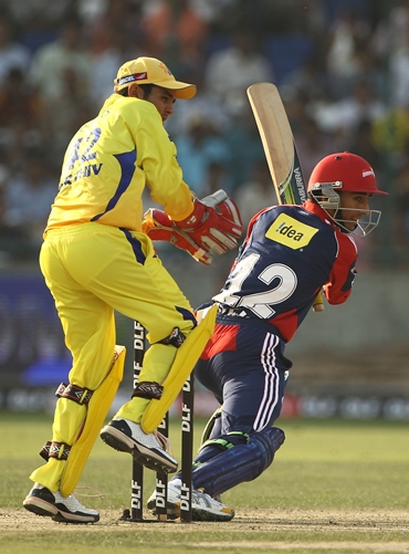 Wicketkeeper Parthiv Patel watches Mithun Manhas guide the ball to the boundary