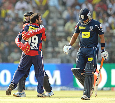 Delhi Daredevils' Amit Mishra and captain Dinesh Karthik celebrate the wicket of Mohnish Mishra (right)