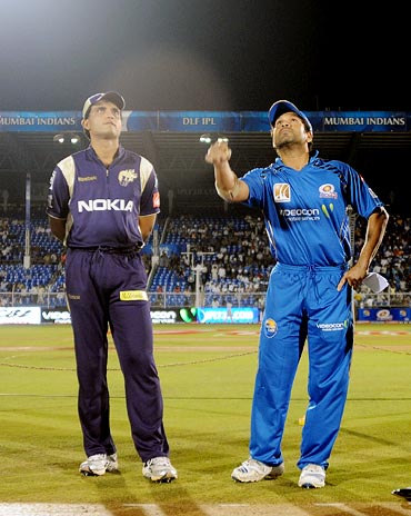 Sachin Tendulkar tosses the coin as Kolkata Knight Riders captain Sourav Ganguly looks on