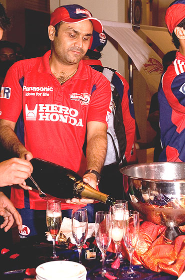 Delhi Daredevils' Virender Sehwag pours champagne for his team-mates at the IPL Nights after-party