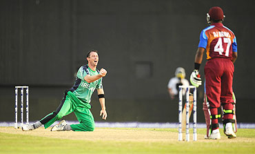 Ireland's Alex Cusack (left) celebrates after catching West Indies' Dwayne Bravo