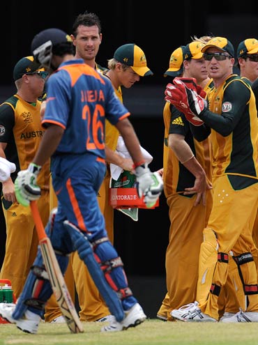 Ravindra Jadeja walks back as Australian players celebrate