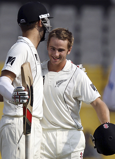 New Zealand's Kane Williamson (right) is congratulated by Daniel Vettori after scoring his century on Sunday