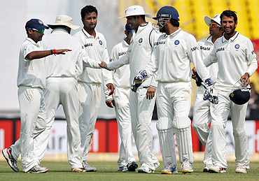 India's Pragyan Ojha (3rd from left) celebrates with teammates after claiming the wicket of Williamson on Sunday