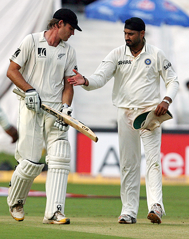 New Zealand's Tim McIntosh is congratulated by Harbhajan Singh after scoring a century