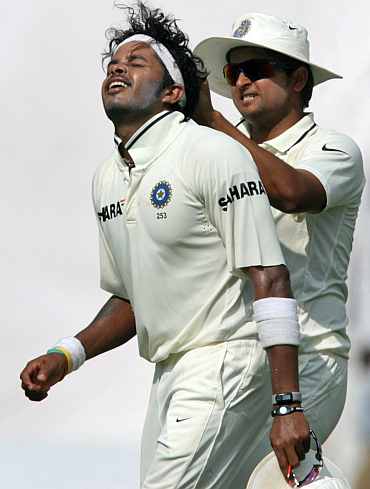 S Sreesanth and Suresh Raina celebrate after picking up a wicket