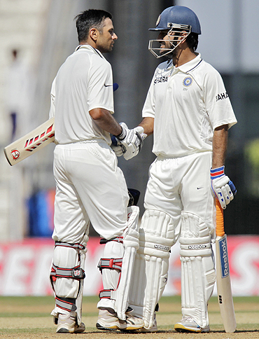 Rahul Dravid is congratulated by Mahendra Singh Dhoni on completing his century on Monday