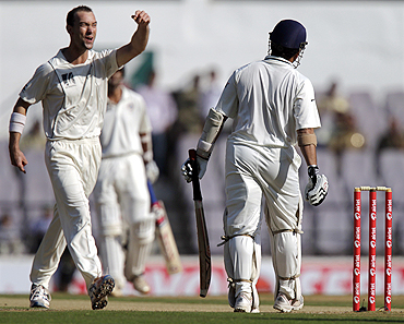 Clint McKay (left) celebrates after claiming the wicket of Sachin Tendulkar on Monday