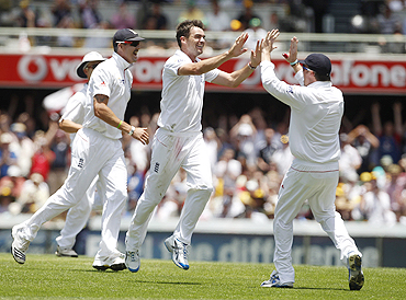 James Anderson celebrates with teammates after claiming the wicket of Ricky Ponting