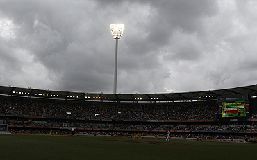 Grey skies surround the Gabba on Friday. Subsequently, play was suspended due to poor light