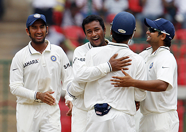 Praghyan Ojha celebrates with teammates after scalping the wicket of Shane Watson