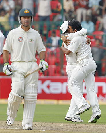 Raina (right) and Sehwag celebrate as Ponting walks off the field after his dismissal