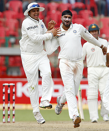 Harbhajan Singh celebrates with Suresh Raina after claiming the wicket of Simon Katich