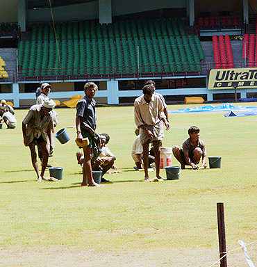 Groundstaff working at the Nehru Stadium in Kochi