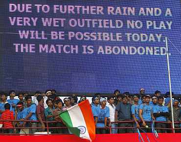 Spectators leave after the first ODI between India and Australia was called off