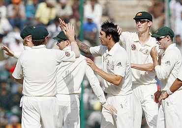 Australian team celebrate at the fall of a wicket