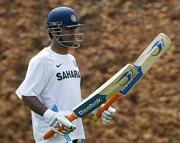 MS Dhoni checks his bat during a practice session in Vizag