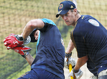 Australia's Tim Paine (left) takes a catch as teammate Cameron White looks on during a practice session in Margao on Saturday