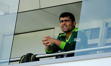 Kamran Akmal watches from the players' balcony at Somerset