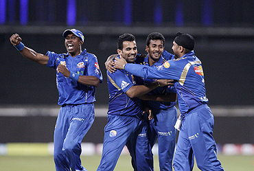 Mumbai Indians' players celebrate after beating Royal Challengers Bangalore