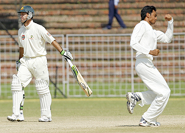 Ricky Ponting (left) walks off the field after being dismissed by Jaidev Unadkat
