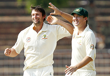 Australia's Ben Hilfenhaus (left) celebrates with teammate Nathan Hauritz after dismissing Ajinkya Rahane