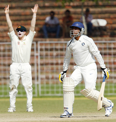 Australia's Steven Smith (left) unsuccessfully appeals for wicket of Pragyan Ojha