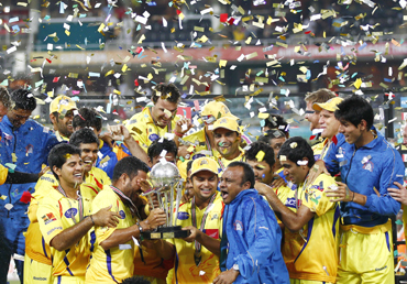 Chennai Super Kings players celebrate with the trophy after winning their final Twenty20 cricket match against the Warriors in Johannesburg