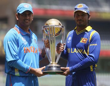 Captains MS Dhoni  and Kumar Sangakkara pose with the ICC World Cup ahead of Saturday's final