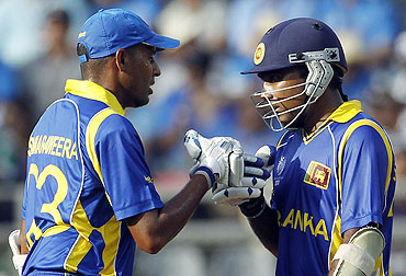 Mahela Jayawardene (right) is congratulated by Thilan Samaraweera after completing his 50