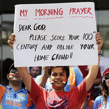 An India fan displays a placard directed at Sachin Tendulkar before the start of the World Cup final