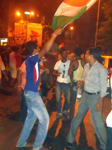 Fans in Mumbai celebrate after India won the World Cup