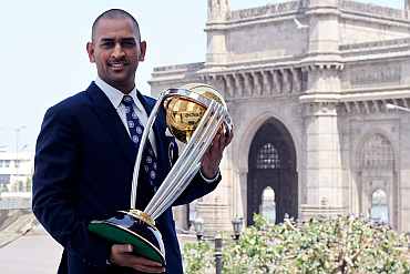 India's cricket team captain Mahendra Singh Dhoni poses with the ICC Cricket World Cup Trophy