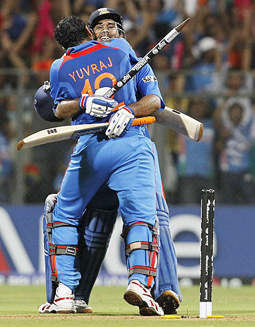 India's Yuvraj Singh hugs captain Mahendra Singh Dhoni after they beat Sri Lanka to win the World Cup final