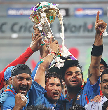 Sachin Tendulkar and Virat Kohli of India celebrate with the World Cup