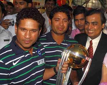 Sachin Tendulkar with the World Cup trophy along with Mukesh Ambani