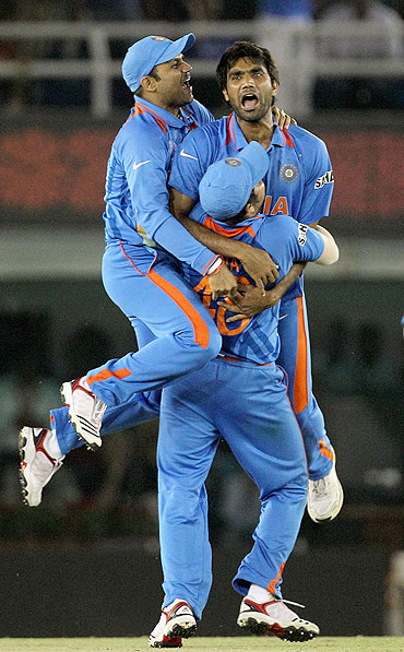 Munaf Patel (centre) celebrates a wicket with teammates
