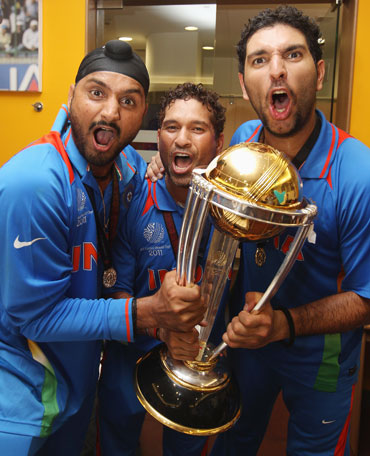 Harbhajan Singh (left),Sachin Tendulkar (centre) and Yuvraj Singh (right) celebrate in the players dressing room after winning the World Cup