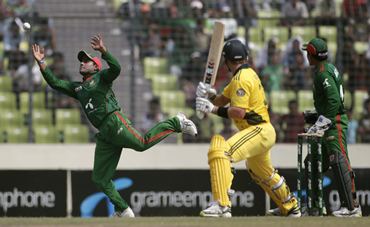 Bangladesh's Imrul Kayes (L) jumps to catch a ball, as Watson watches