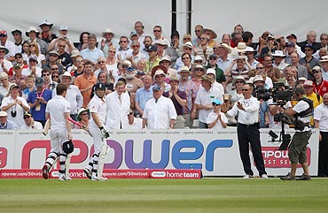Reserve Umpire Tim Robinson tells Ian Bell and Eoin Morgan not to leave the field after the former was controversially run out