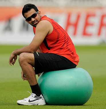 India's Zaheer sits on a ball during a training session