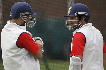 Sachin Tendulkar and Virender Sehwag chat during a training session