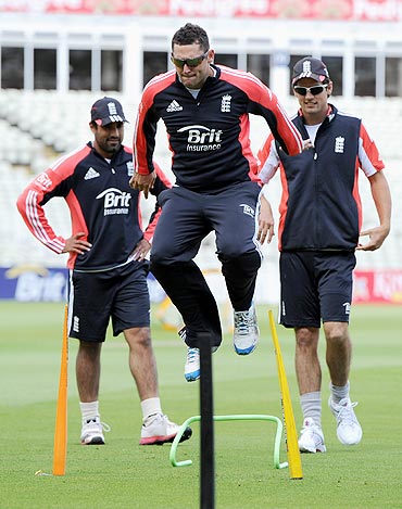 Tim Bresnan goes through the grind as Ravi Bopara and Alastair Cook watch during a nets session