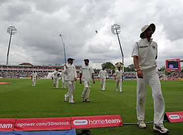 Indian players walk back to the pavillion after bad light stopped play