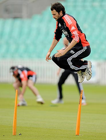 England's Graham Onions leaps during a training session