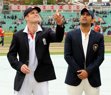 England captain Andrew Strauss (L) tosses the coin, as India's captain Mahendra Singh Dhoni calls before the fourth and final Test at The Oval ground in London
