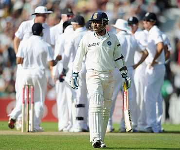 Virender Sehwag walks back after being dismissed