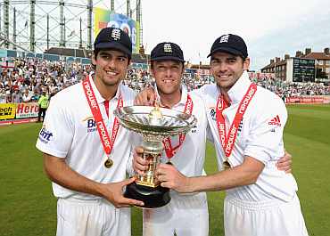 Alastair Cook, Graeme Swann and James Anderson of England celebrate the series victory with the Pataudi Trophy